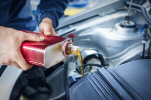 mechanic-changing-engine-oil-car-vehicle-min